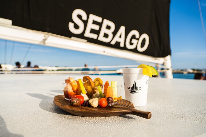 Key West Sunset Sail with Open Bar, Live Music and Hors D'oeuvres - A sunset sail with a party in the background
