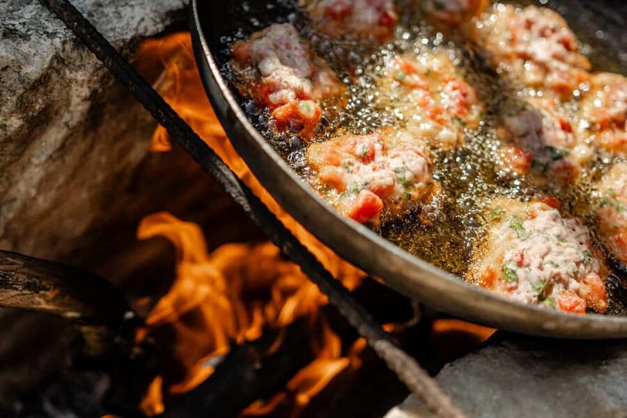 Naxos: Family Farm-table Cooking, Kouros Tour & Live Music - Cooking over fire and a wood oven