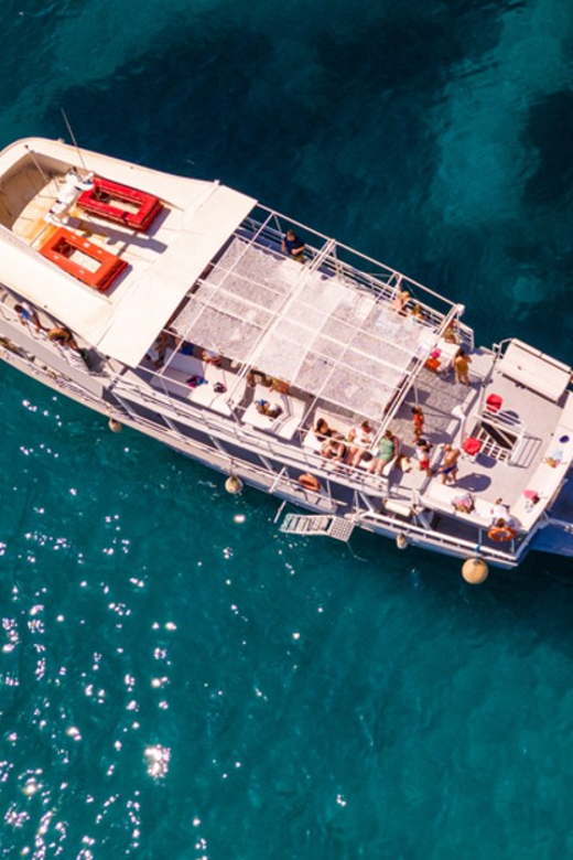 Rhodes: Sunset Cruise with Live Music, Wine & Greek Buffet - Finding the sunset at sea