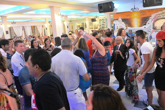 Traditional Greek Night live Music & Dinner Show in Santorini - Plate smashing and the crowded dance floor